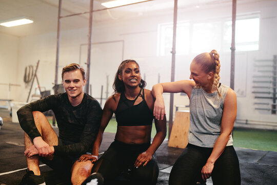 Diverse young friends hanging out at the gym together