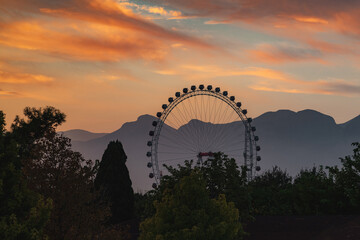Fototapeta na wymiar Big Ferris wheel in the amusement park at sunset in Konyaalti Antalya