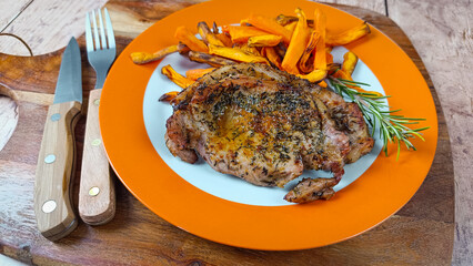 steak de porc et frites de patates douces dans une assiette