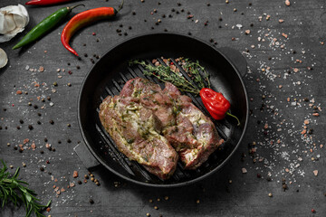 Pork tenderloin in marinade with herbs.