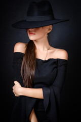 Elegant Woman in Black Hat and Off-Shoulder Dress