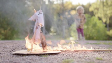 Toddler looks on as rocket launch experiment fails and burns out, low angle