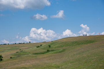 Radome (antenna dome) on the Wasserkuppe with a meadow and blue sky