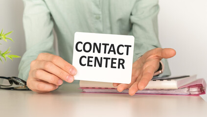 Woman hand holding card with the word Contact Center.