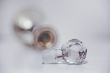 Intentional soft focus image of an old antique perfume bottle with an ornate perfume dispenser as...