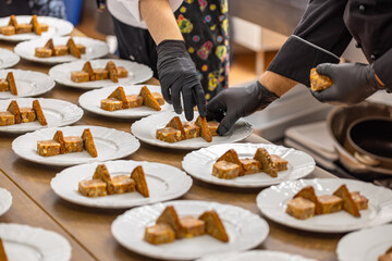 Chefs are arranging meat and toast bread pieces