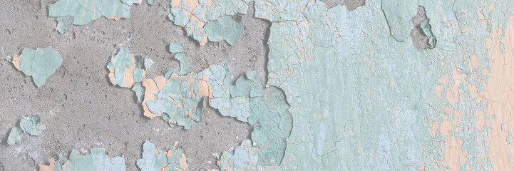 Peeling paint on the wall. Old concrete wall with cracked flaking paint. Weathered rough painted surface with patterns of cracks and peeling. Grunge texture for background and design. High resolution.