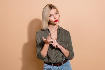 Photo of unhappy unsatisfied lady wear khaki shirt looking you counting fingers isolated beige...