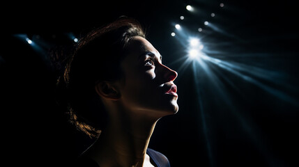 Girl in the dark illuminated by a spotlight
