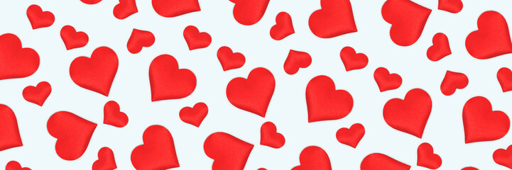 Banner with pattern made of red hearts. Creative composition on a blue background.