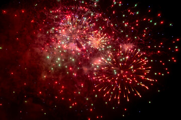 Looking up at exploding fireworks against a night sky © lemanieh