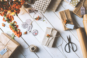 Christmas gifts wrapped with kraft paper on wooden table