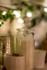 A close up of decorative candles in jars, at Christmas time