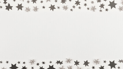 White background with paper texture. small stylized snow crystals and stars