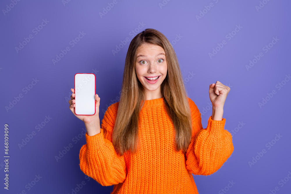 Poster portrait of teen girl raised fist up celebrating black friday discount code scanning hold smartphone