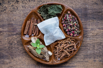 Chinese herbal medicines are believed to help relax and help with sleep, such as:polygala tenuifolia willd, acorus calamus roots and other herbs on an old wood background.