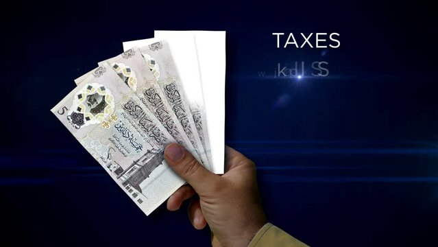 Libya Dinar paper note holding. Fan of LYD banknotes in hand. Metaphor concept of income loss, cost of live, tax, credits and money decline.