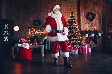 Photo of dreamy thoughtful santa claus dressed red eyewear enjoying decorations indoors christmas...
