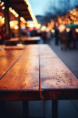 Empty wooden table in a street cafe with blurred people in the background.