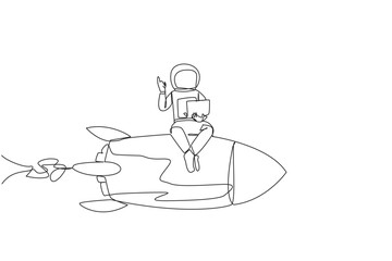 Single continuous line drawing young energetic astronaut sitting on flying rocket holding laptop raise one hand. Expedition to repair damage near the lunar surface. One line design vector illustration