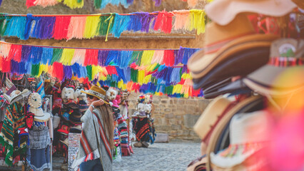 Traveler hipster girl in hat with backpack exploring market of Ollantaytambo Ruins in Sacred Valley of Peru. travel Concept