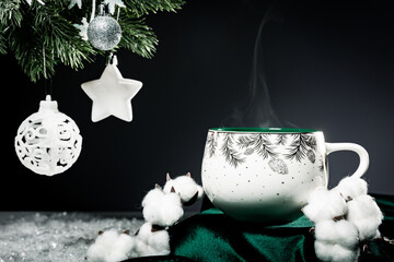 christmas mug on the dark background and Christmas ball on the Christmas tree