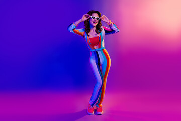 Photo of pretty excited lady wear striped overall arms hands dark glasses having fun isolated gradient pink purple color background