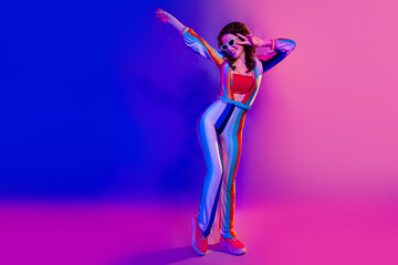 Full size photo of pretty cheerful funky girl have good mood dancing chilling isolated on colorful...