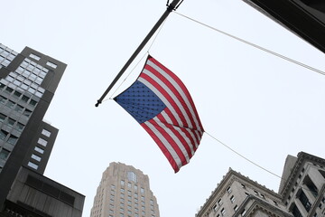 American flag waving on Wall Street, NYC