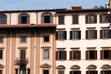 Colorful historic streets of Florence, Italy. Narrow old street, building's facade, brick walls.