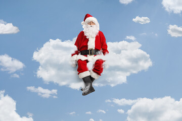 Santa claus floating on clouds