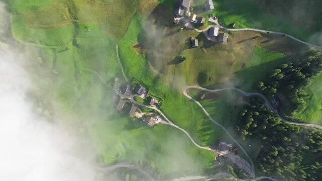 As if plucked from a painter's canvas, the scattered homes and farms of Val Badia grace the landscape, complemented by the emerald expanse of surrounding meadows.