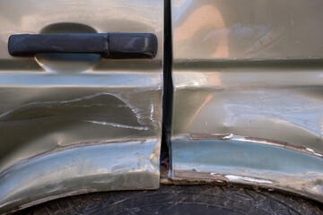 Damaged car door and fender after an accident