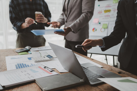 Group of businessmen working together to calculate income, They are revising the financial numbers, Take out financial documents and check them with a calculator, financial idea.