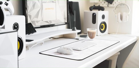 Desktop with a white keyboard, white mouse and glass coffe cup on a comfortable workplace. A home...