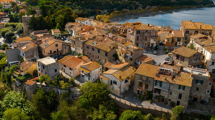 Fototapeta na wymiar Aerial view of the historic center of Anguillara, in the metropolitan city of Rome, Italy. The town is located on the shores of Lake Bracciano.