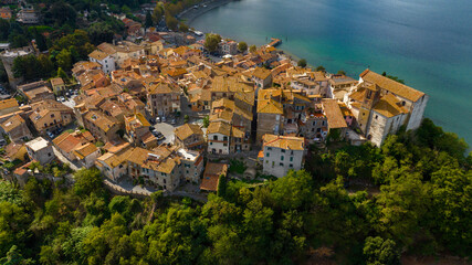 Fototapeta premium Aerial view of the historic center of Anguillara, in the metropolitan city of Rome, Italy. The town is located on the shores of Lake Bracciano.