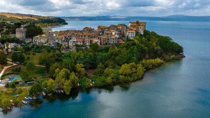 Fototapeta na wymiar Aerial view of the historic center of Anguillara, in the metropolitan city of Rome, Italy. The town is located on the shores of Lake Bracciano.