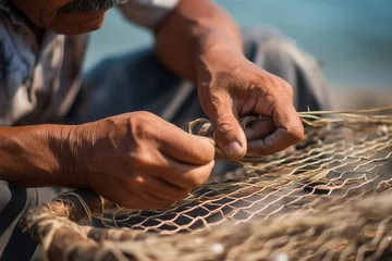 Gordijnen the worn-out hands of a man weaving a fishing net. Heritage Craft © Margo_Alexa