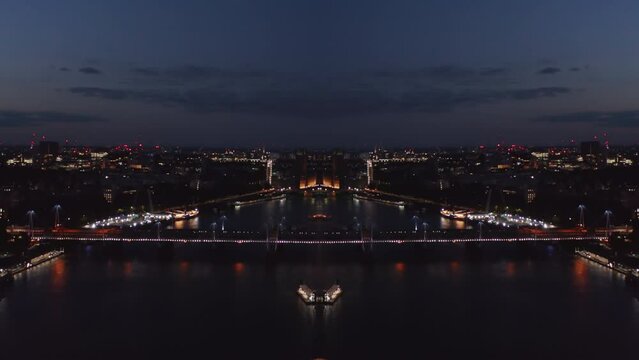 Aerial view of night London. City and illuminated bridge over river. Abstract computer effect digital composed footage
