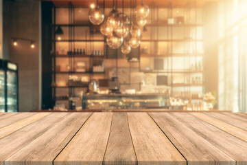 Empty wooden table space platform and blurred resturant or coffee shop background for product...