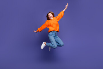 Fototapeta na wymiar Full length photo of young teenage girl jumping trampoline looks like she flying with wings hands isolated on violet color background