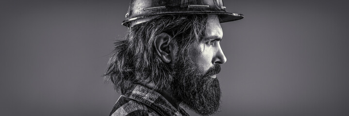 Bearded man worker with beard in building helmet or hard hat. Man builders, industry. Black and white
