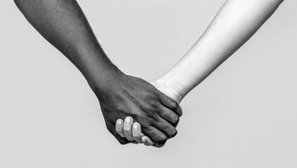 African peace symbol. Woman and man holding hands together. White woman, african man holding hand friendship symbol. Black and white - Powered by Adobe