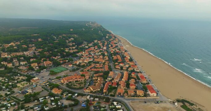 Aerial view of port Leucate with mediterranean sea in background, sunset France, Occitanie