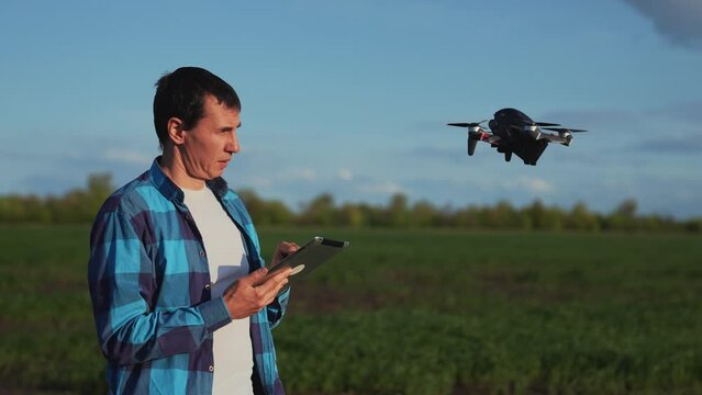 Agriculture. Farmer agronomist with the help of a drone studies farm. Drone modern technology. An agronomist using 3D image checks field with organic products. Agricultural business modern technology