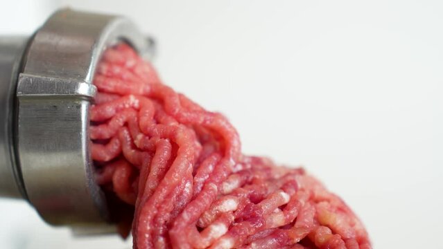 Beef mince in a mincing machine, close up.