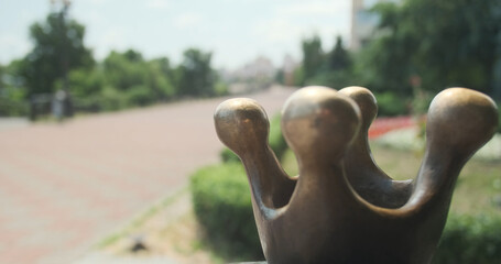 Part of bronze sculpture for happiness. Tradition for tourists rub monument for good luck. Close-up.