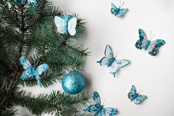 A spruce branch decorated with butterflies and balloons