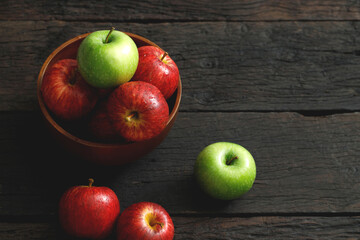 fresh red and green apples on the wooden floor